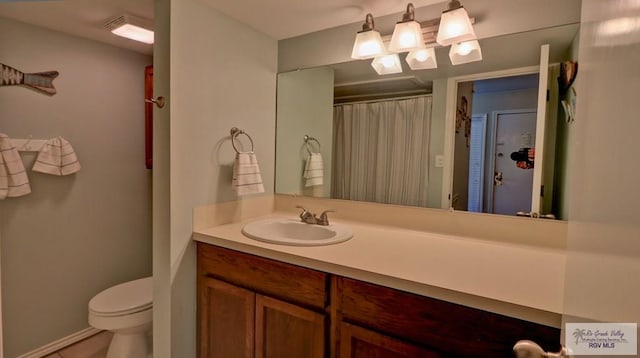 200 S Padre Blvd Unit 1303, South Padre Island, TX 78597 - full bathroom featuring vanity, toilet, a shower with shower curtain, and baseboards