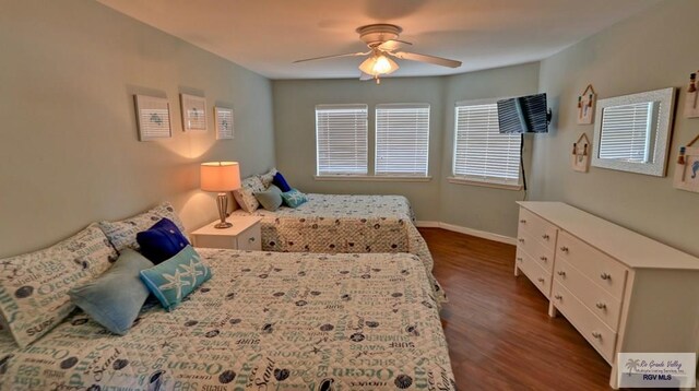 bedroom with ceiling fan and dark hardwood / wood-style floors