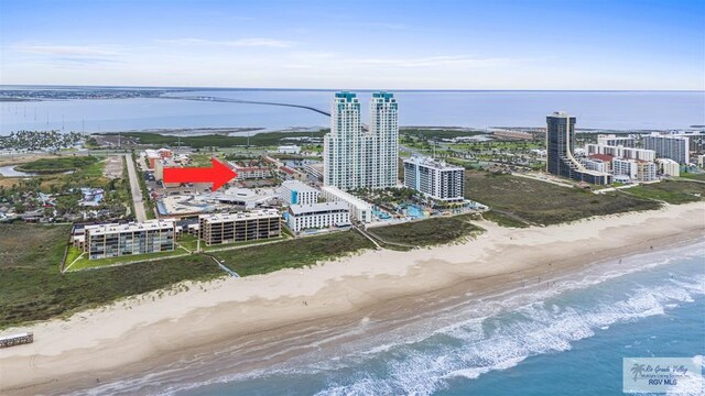 birds eye view of property with a water view and a view of the beach