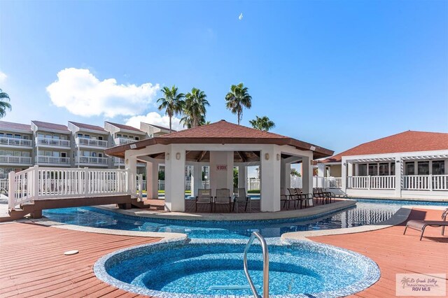 200 S Padre Blvd Unit 1303, South Padre Island, TX 78597 - swimming pool featuring a gazebo, a deck, and an in-ground hot tub