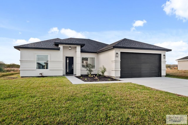 prairie-style home with a front yard and a garage