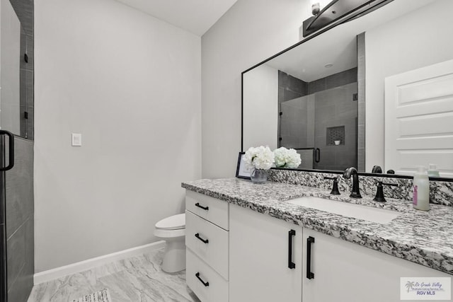 bathroom featuring toilet, an enclosed shower, and vanity