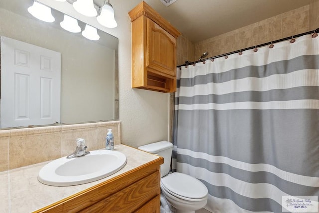 5662 Rustic Manor Dr, Brownsville, TX 78526 - bathroom featuring toilet, vanity, a shower with shower curtain, and tasteful backsplash