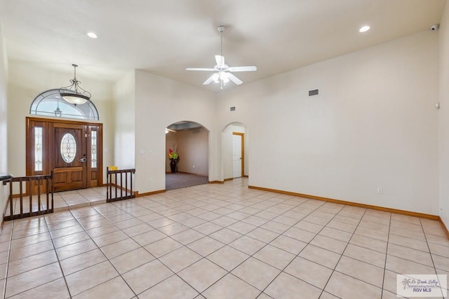 5662 Rustic Manor Dr, Brownsville, TX 78526 - entrance foyer with arched walkways, light tile patterned flooring, a ceiling fan, baseboards, and recessed lighting