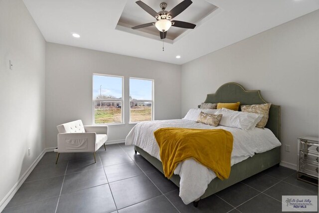 473 Santiago St, La Feria, TX 78559 - bedroom featuring ceiling fan, baseboards, a tray ceiling, and dark tile patterned flooring