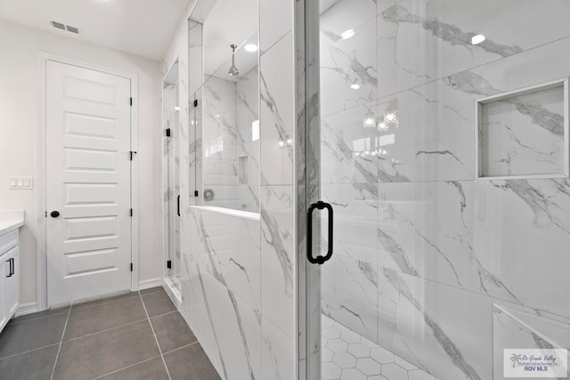 473 Santiago St, La Feria, TX 78559 - bathroom featuring vanity, tile patterned flooring, visible vents, and a marble finish shower