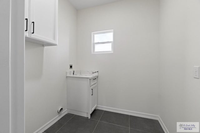 473 Santiago St, La Feria, TX 78559 - washroom with baseboards, hookup for an electric dryer, and dark tile patterned floors