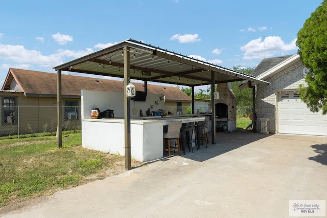 view of patio / terrace with a fireplace and a bar