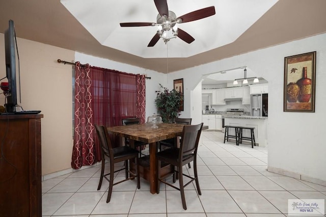 tiled dining space featuring ceiling fan