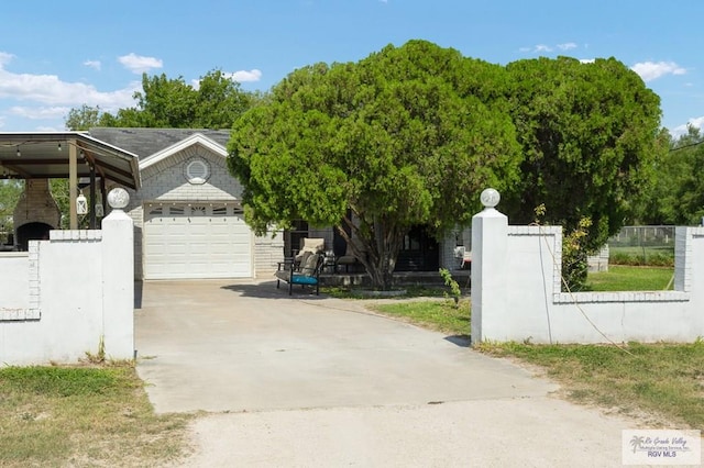 view of gate with a garage