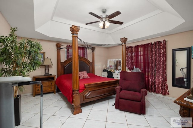 bedroom featuring a raised ceiling, ceiling fan, and light tile patterned floors