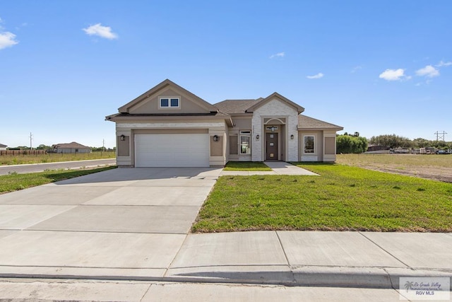 23547 Murphy Ct, Harlingen, TX 78552 - view of front of home with driveway, a front lawn, a garage, and stucco siding