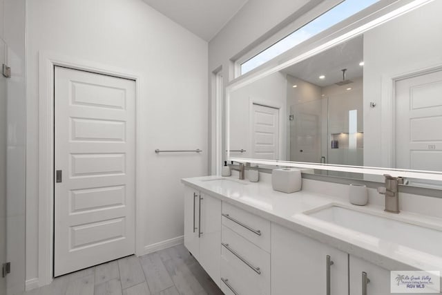 269 Cameo Dr, San Benito, TX 78586 - full bath featuring a shower stall, double vanity, baseboards, lofted ceiling, and wood finished floors