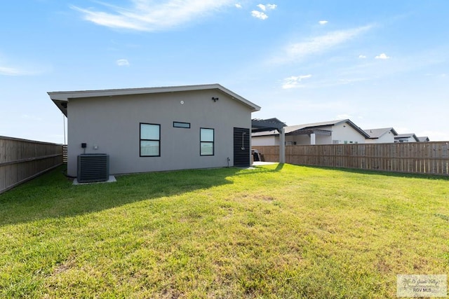 269 Cameo Dr, San Benito, TX 78586 - back of property featuring central air condition unit and stucco siding