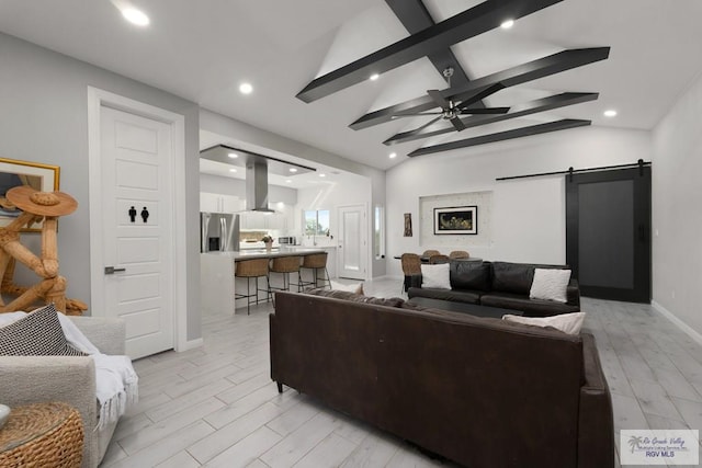 269 Cameo Dr, San Benito, TX 78586 - living room featuring a barn door, a ceiling fan, recessed lighting, light wood-type flooring, and baseboards