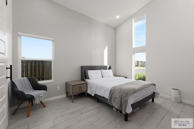 269 Cameo Dr, San Benito, TX 78586 - bedroom featuring high vaulted ceiling, light wood-style floors, and baseboards