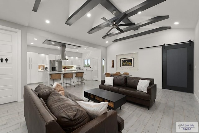 269 Cameo Dr, San Benito, TX 78586 - living area with a barn door, a ceiling fan, light wood-type flooring, recessed lighting, and baseboards