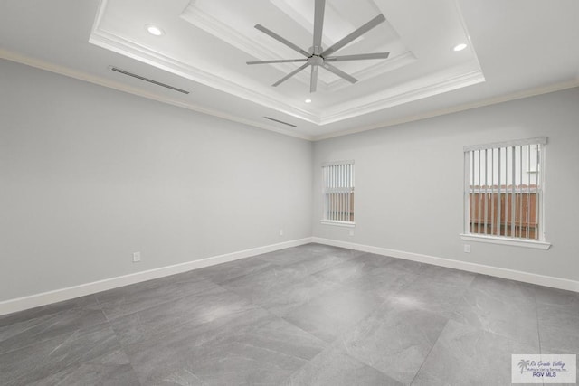 unfurnished room featuring ceiling fan, crown molding, and a tray ceiling