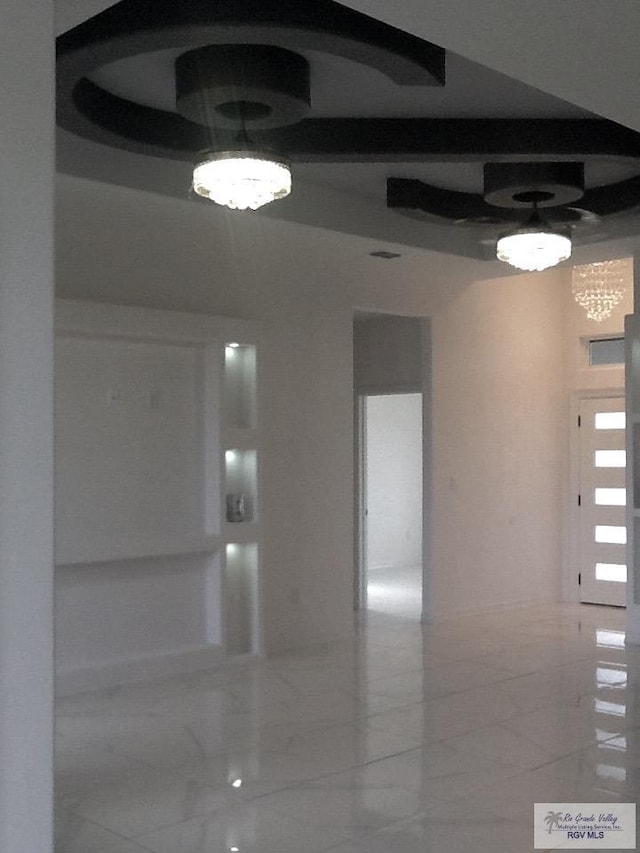 unfurnished room with a chandelier