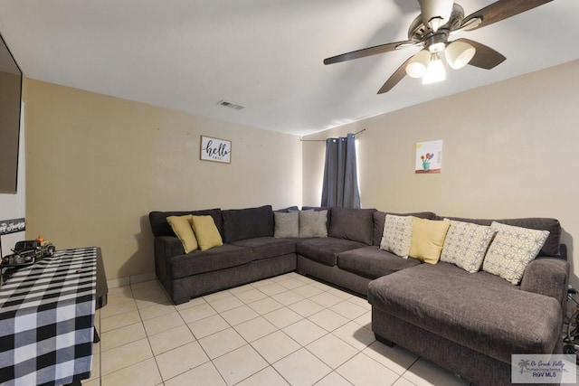 living room with light tile patterned floors, visible vents, and a ceiling fan