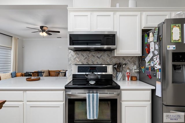 2853 Fleet St, Brownsville, TX 78521 - kitchen featuring stainless steel appliances, a ceiling fan, backsplash, light countertops, and white cabinetry