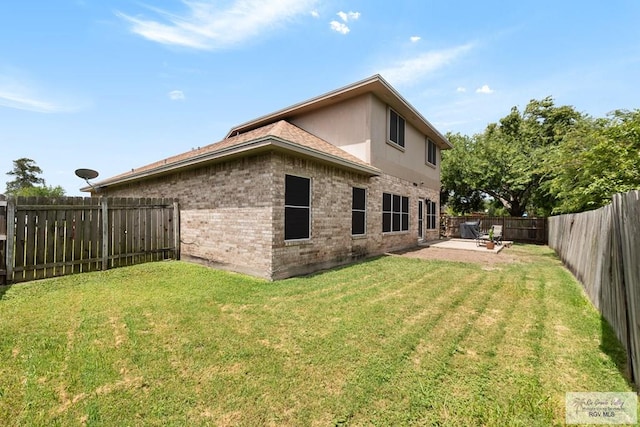 2853 Fleet St, Brownsville, TX 78521 - rear view of house with brick siding, a fenced backyard, and a patio