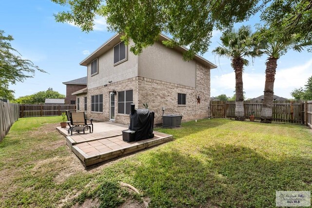 2853 Fleet St, Brownsville, TX 78521 - rear view of house featuring brick siding, a patio, a fenced backyard, and stucco siding
