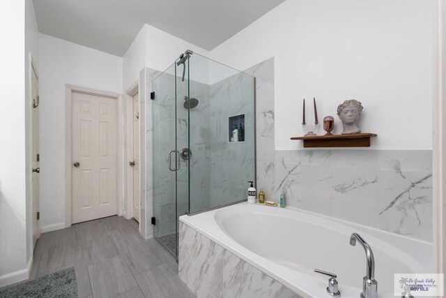 2853 Fleet St, Brownsville, TX 78521 - full bathroom featuring a marble finish shower and a bath