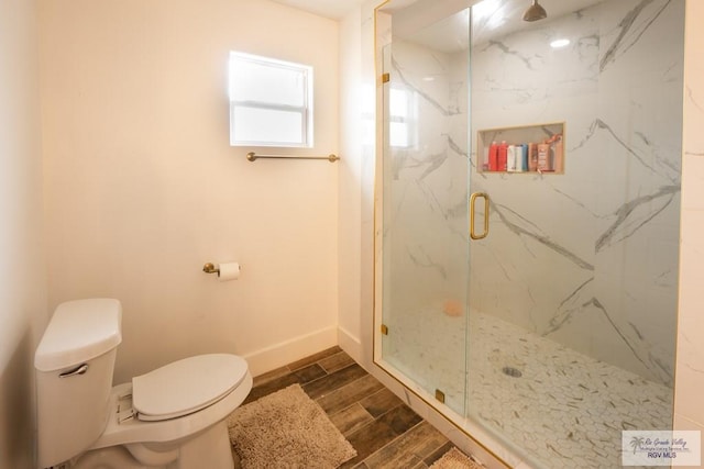 bathroom featuring toilet and an enclosed shower