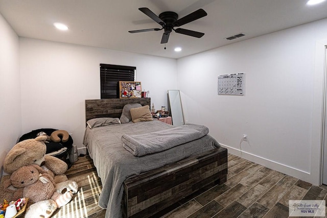 bedroom with ceiling fan and dark hardwood / wood-style flooring