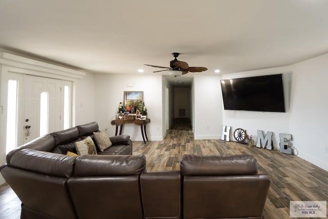 living room with wood-type flooring and ceiling fan