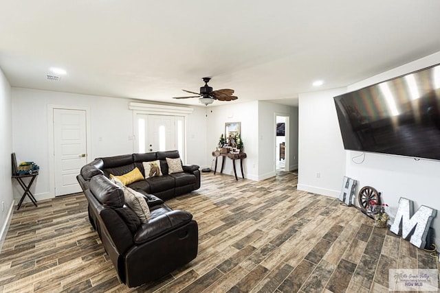 living room featuring ceiling fan and wood-type flooring