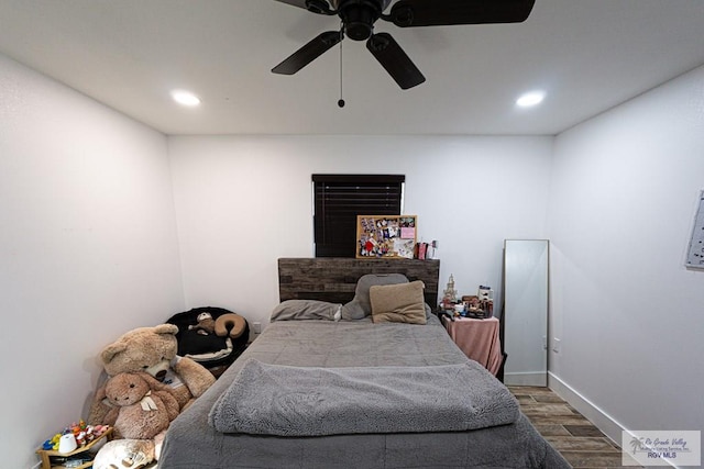 bedroom with ceiling fan and wood-type flooring