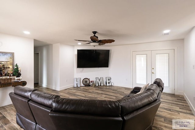 living room with hardwood / wood-style flooring, ceiling fan, and french doors