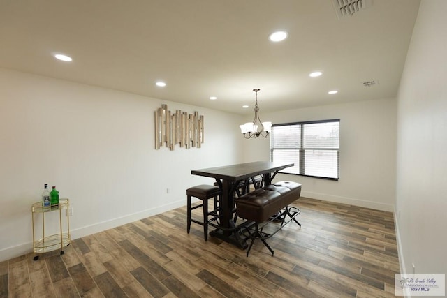 dining room featuring a notable chandelier and dark wood-type flooring