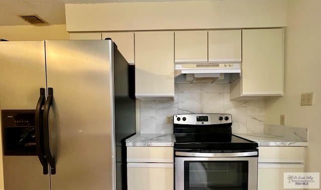 kitchen featuring light stone countertops, backsplash, and stainless steel appliances