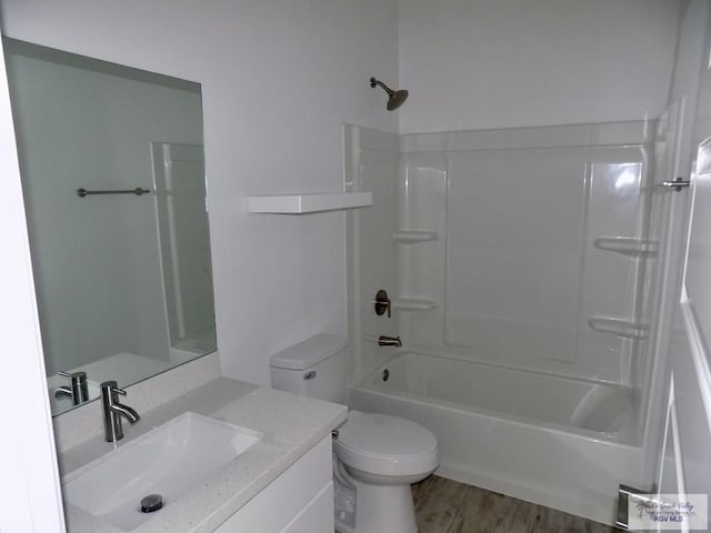 full bathroom featuring vanity, hardwood / wood-style flooring, toilet, and shower / bathtub combination