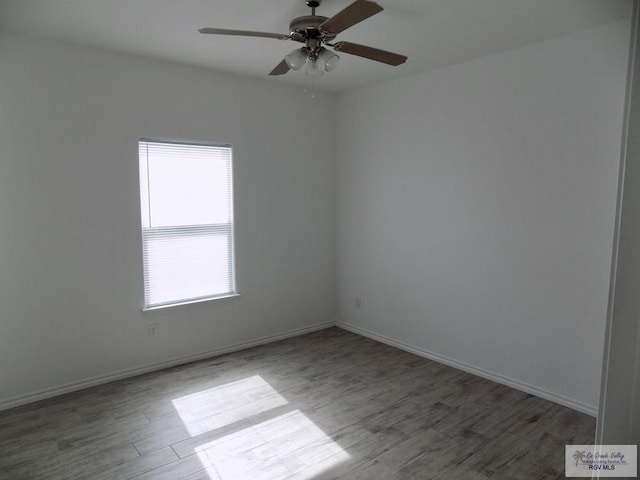 spare room featuring wood-type flooring and ceiling fan