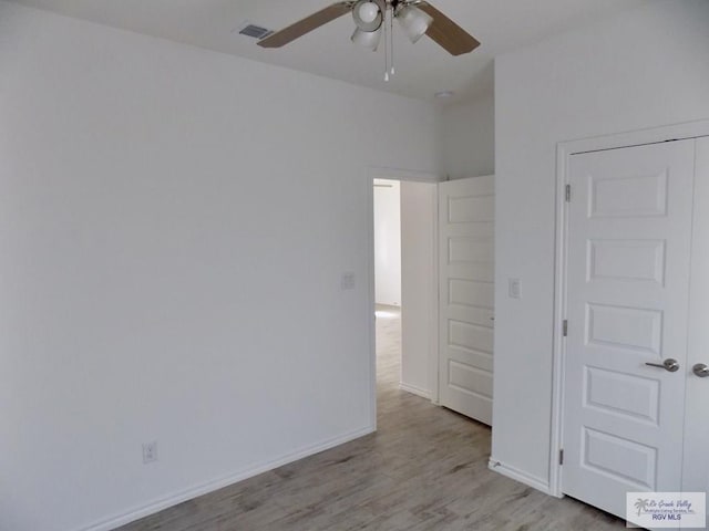 unfurnished bedroom with ceiling fan and light hardwood / wood-style flooring