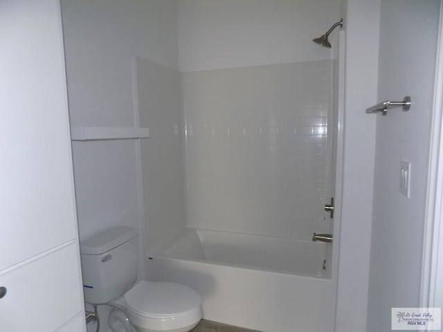 bathroom featuring bathtub / shower combination and toilet