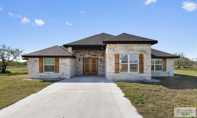 view of front facade with french doors and a front lawn