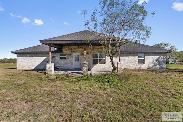 back of house with a lawn and a patio