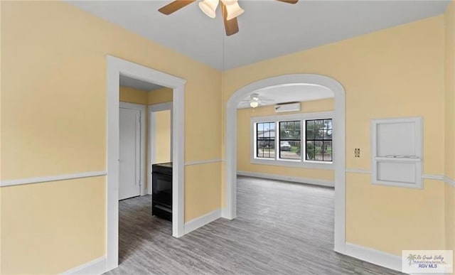 284 Corona Crescent Cir, San Benito, TX 78586 - unfurnished room with ceiling fan, arched walkways, baseboards, and a wall unit AC