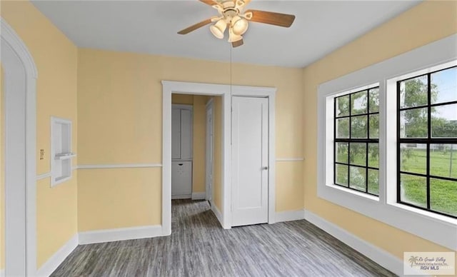 284 Corona Crescent Cir, San Benito, TX 78586 - spare room featuring baseboards, wood finished floors, ceiling fan, and arched walkways