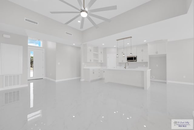 7336 San Andres St, Brownsville, TX 78526 - unfurnished living room featuring a sink, baseboards, a ceiling fan, recessed lighting, and light marble finish floors