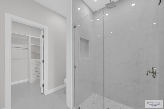 7336 San Andres St, Brownsville, TX 78526 - bathroom with marble finish flooring, a marble finish shower, toilet, a spacious closet, and baseboards