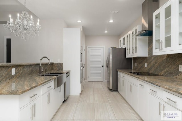 kitchen featuring stone counters, stainless steel appliances, and white cabinets