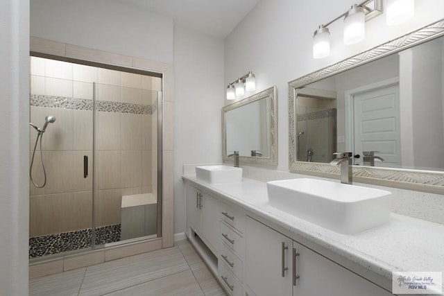 bathroom with vanity, an enclosed shower, and tile patterned floors