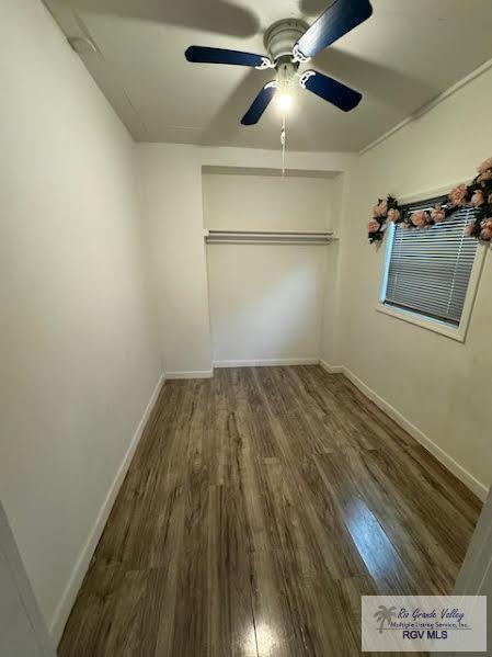 unfurnished bedroom featuring dark hardwood / wood-style flooring, a closet, and ceiling fan