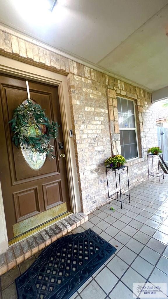 2839 Regency Dr, Brownsville, TX 78526 - view of exterior entry featuring covered porch and stone siding